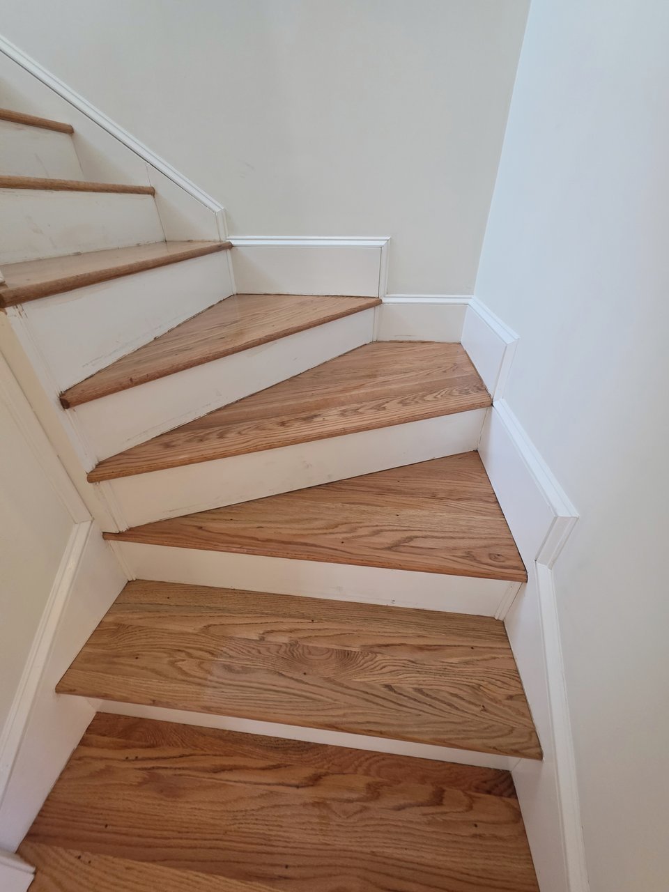 Light wood stair treads at a turning landing